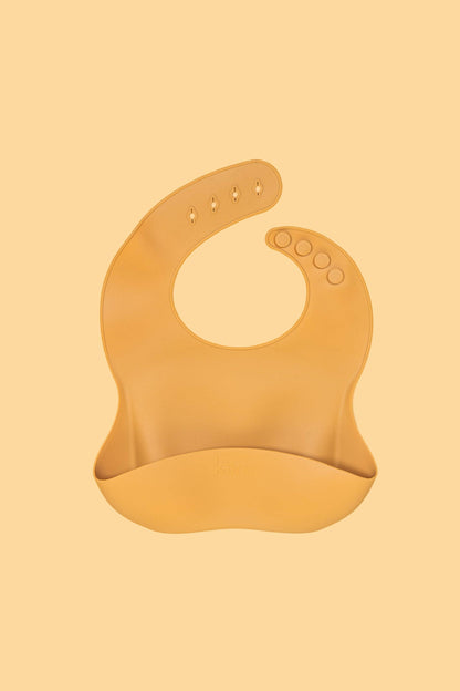 Kiin silicone baby bib with crumb-catching pocket - mustard 1