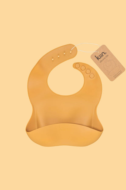 Kiin silicone baby bib with crumb-catching pocket - mustard tag 1